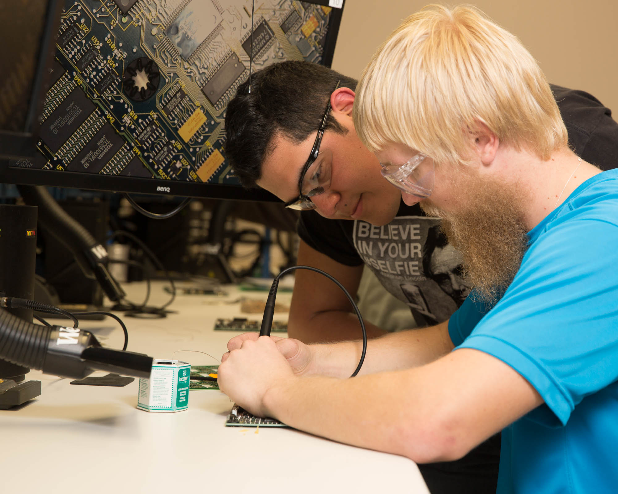 Two students working on electrical equipment